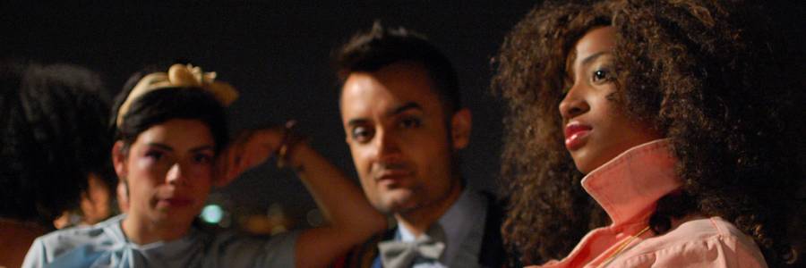 Two women and a man dressed in fancy clothes